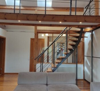 A two-level apartment located on the attic floor is for sale.