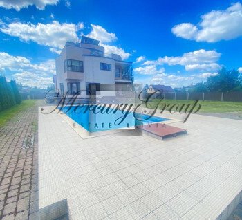 Three-story house with a pool in Catlakalns
