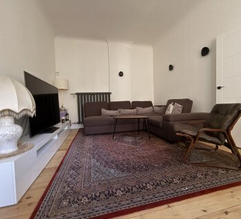 A spacious 4-room apartment is for sale in a renovated building in the center of Riga
