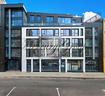 A commercial space on the ground floor is offered with large display windows