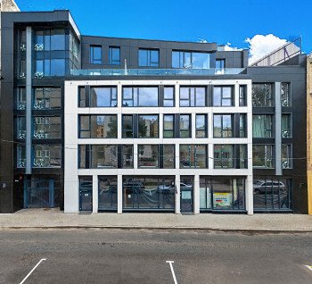 A commercial space on the ground floor is offered with large display windows